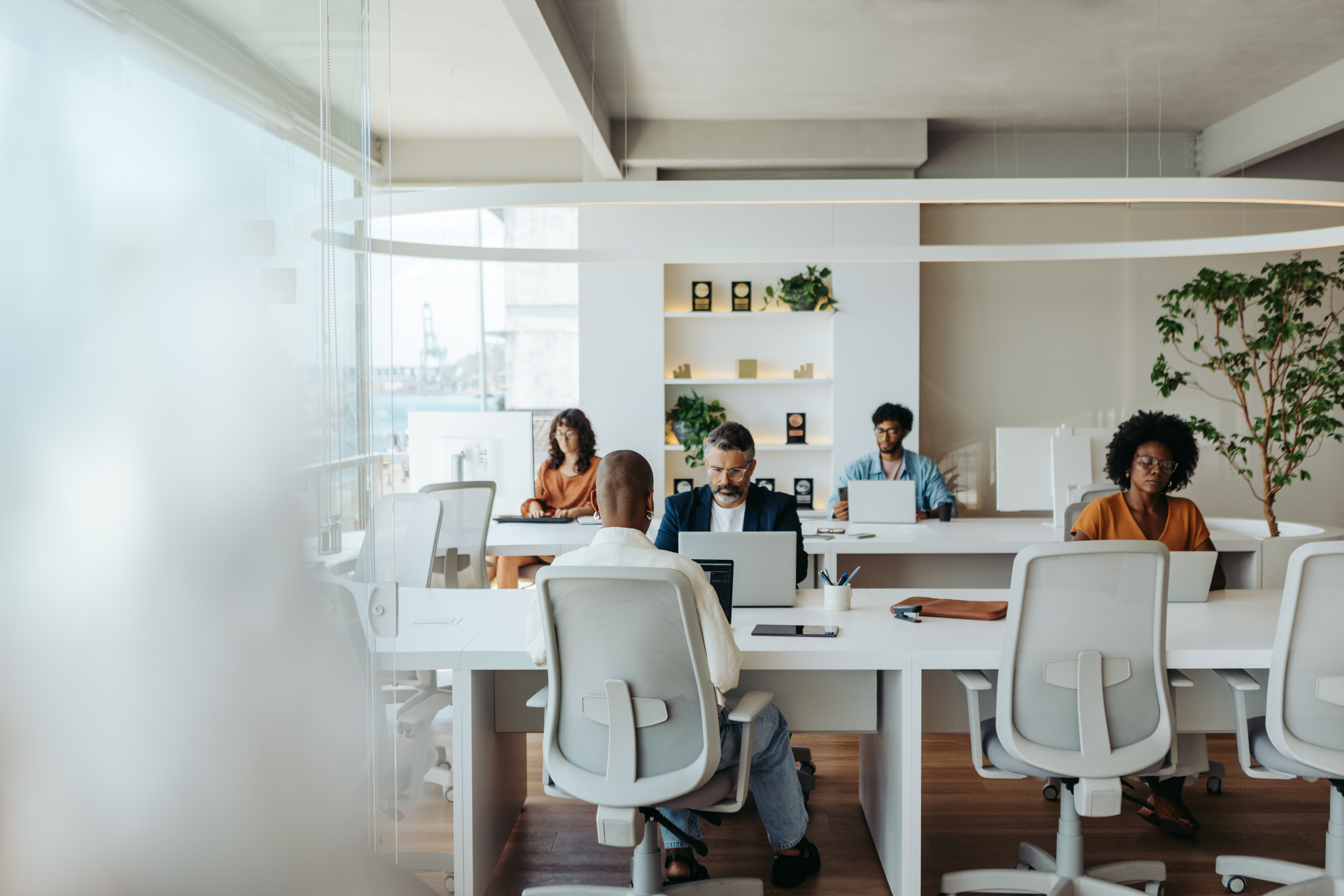 Multicultural Colleagues Working Together In A Creative Coworking Office