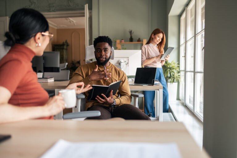 Diverse Team Collaborating in Modern Office Environment with Natural Lighting