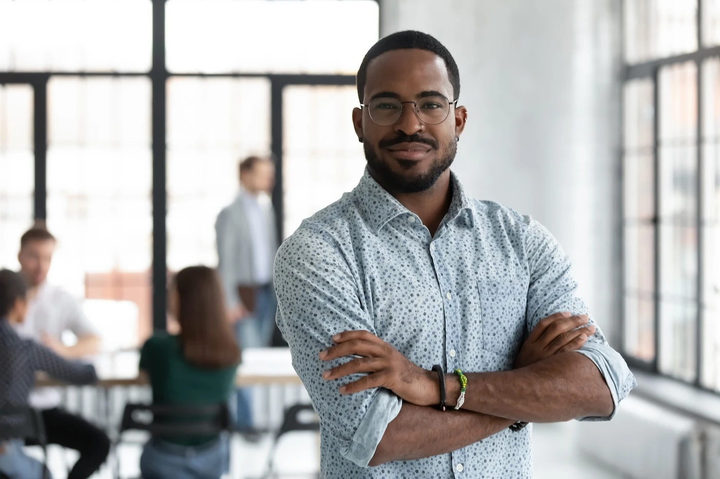 Head shot portrait confident young African American businessman wearing glasses looking at camera, successful executive startup founder standing in modern office room with arms crossed SSUCv3H4sIAAAAAAAACmxSTW/UMBD9K8U3pDWKHSex98y/aKrKX9kNTeIocaBVtVLLFSQ4Ig6V4I5URJEqqvIbnH/EONuqAnGINfP85o3nTc6RkmOt0foc1U0zjX6QvnYdWicrNNjO2GEJram9G2rZLJmSXm872Vq07qam2a3Q6KWfRjuCDmRaersB+pI/Njg8jzhaIwT0ScVgt/oPdrRCcmM7fRZrzWBlO/o6tjpERQa8QsBBKEVHO2g12MbKpfEhqlhWJDaxOCG5xSwhCZYkJ9jmghRMEKEUhdpccsU4sdikicZMpwWWRUpxJQqWxVIlNdCyIuVCMI0NtwlmhQE1YwTmlqdMWc5VSoBGlVFJRQRmAMJhDJYq0zhnlmTU0szkFmgqzzOSaYa1EgVmhFvM80RgqlhqeMZ5RSWC0U/eeDu0Dz7KydQu2vDaadkAmALYD7Wuu82e4fw2bghsdFPnh7O9lY1zvVQNeFZBmV2hrRxHIJgHIK4IVu3avUjnfDQwVhrYHEQkpYywIktFwnguMpKixx1vayiMjWIlhPqkNg/PrUEfUUklN5JibgqCo1GwBPBOV1pQY8C6RILY1DdOGr9MN24nD1MvYmhNVn9tHVJpnLJPt4SmQ7VEqt4scL91USlW2t6NtV8AeBUgWnb/cHrXmWx/5xo3Dcqd7ts0soW5IqM+9XKJWjc+icGIlRva5Ycd5AhPXryG1fTSbwF8uS7LZwfhS/garsLn8Kksw9V8EW7DD/juw3W4m9+VJU2I2J/HJDkG5q/57fwhfJ8v5vdlKZ4fhG/hJtzOl/Nl+B3uDyjIfAx34ScQL0HkPtyA6HVZZuTFq36Ddn8AAAD//wMAWDWV88QDAAA=