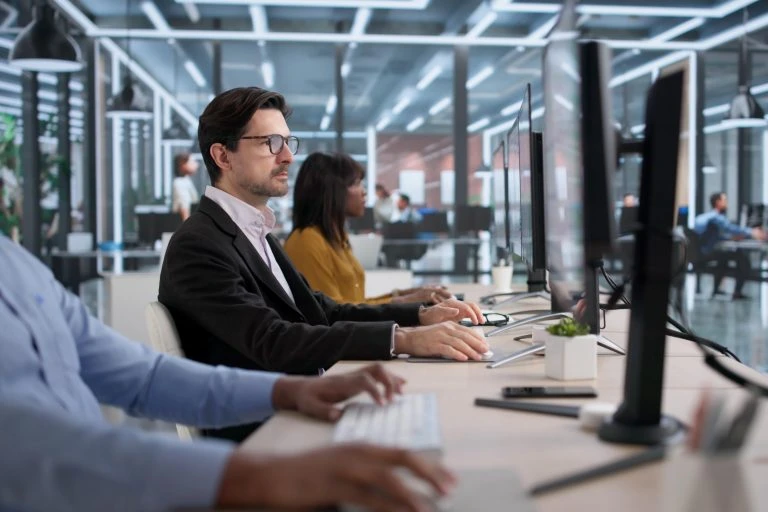Diverse Team Of Professionals, Including Analysts And Auditors, Study