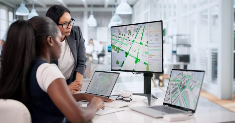 Civil Engineers Review 3D City Road Maps On Laptops